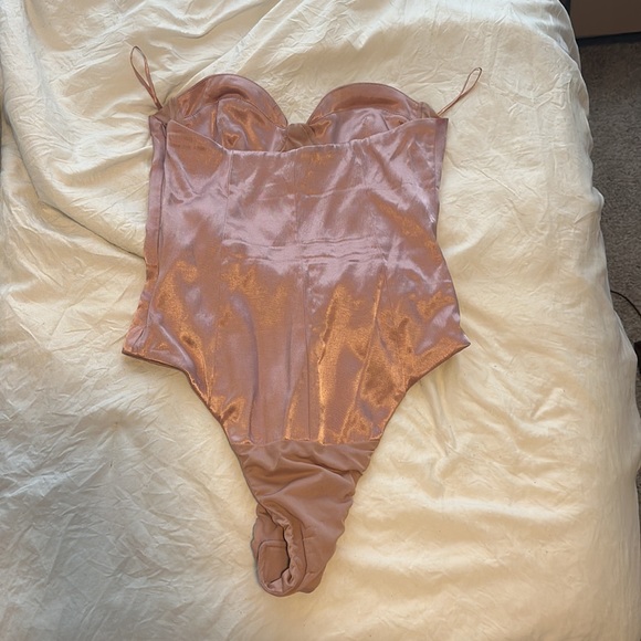 This is an off white body suit the zips up on the side - Picture 2 of 2